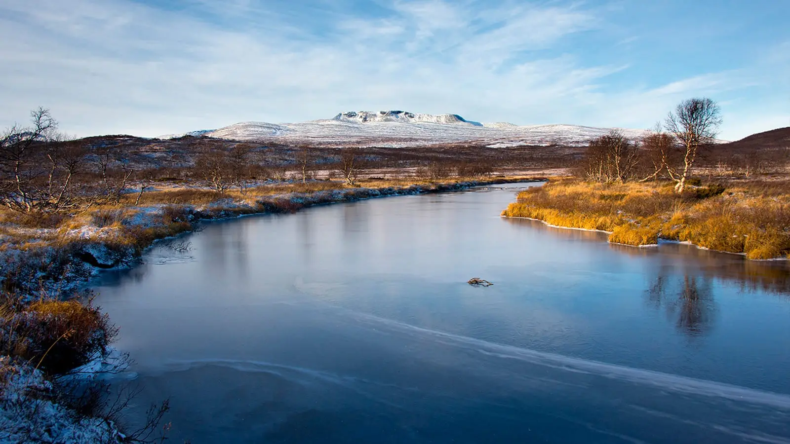Mountains and river in central Norway in autumn light